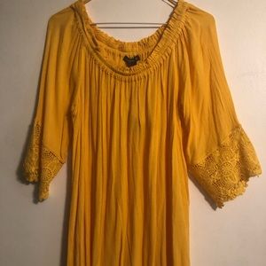 A yellow top with lace accents on the sleeves.